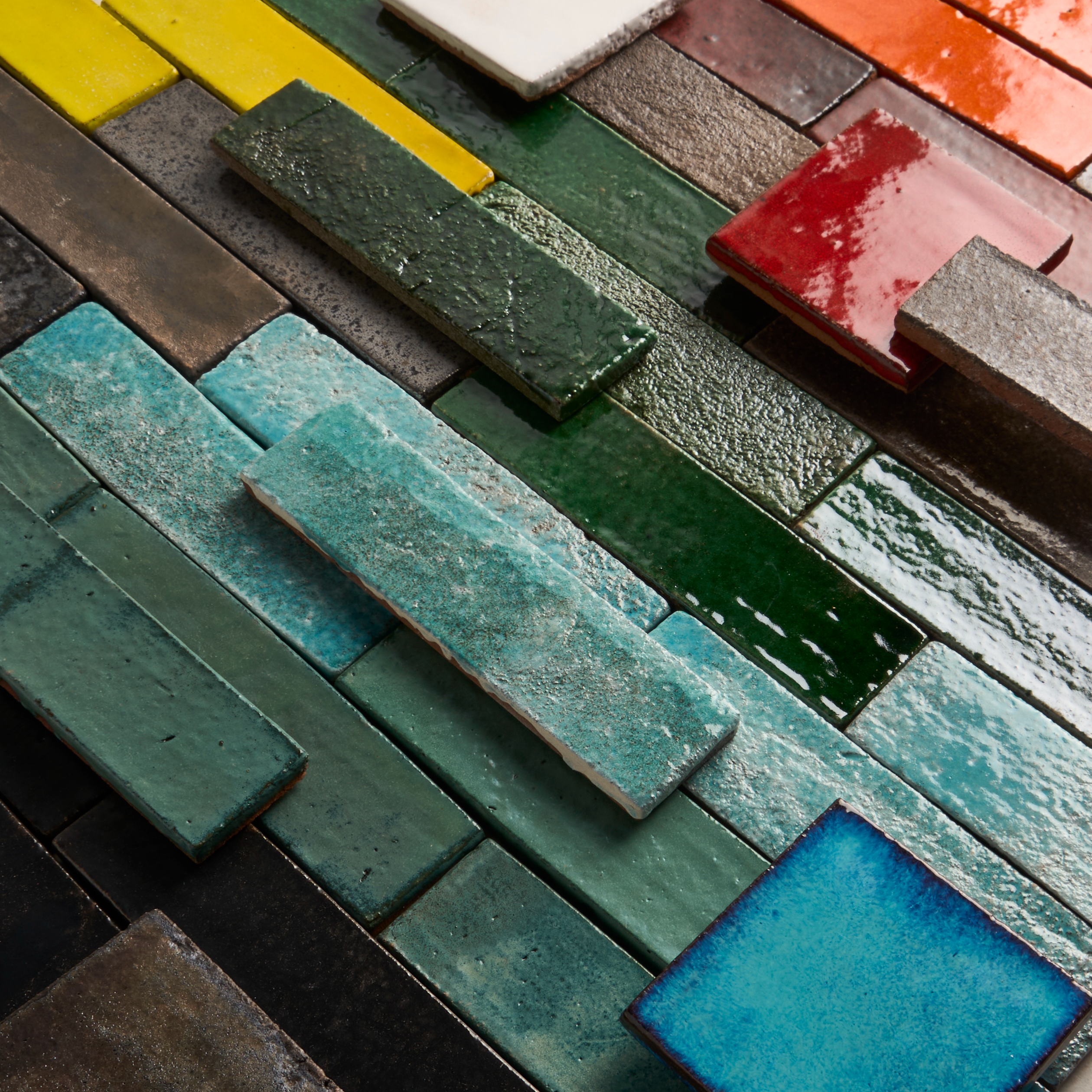 colorful glazed terracotta tiles stacked from a top-down view